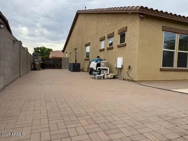 a view of a patio with a table and chairs under an umbrella