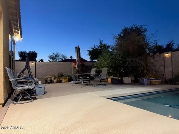 a view of a house with a swimming pool and sitting area