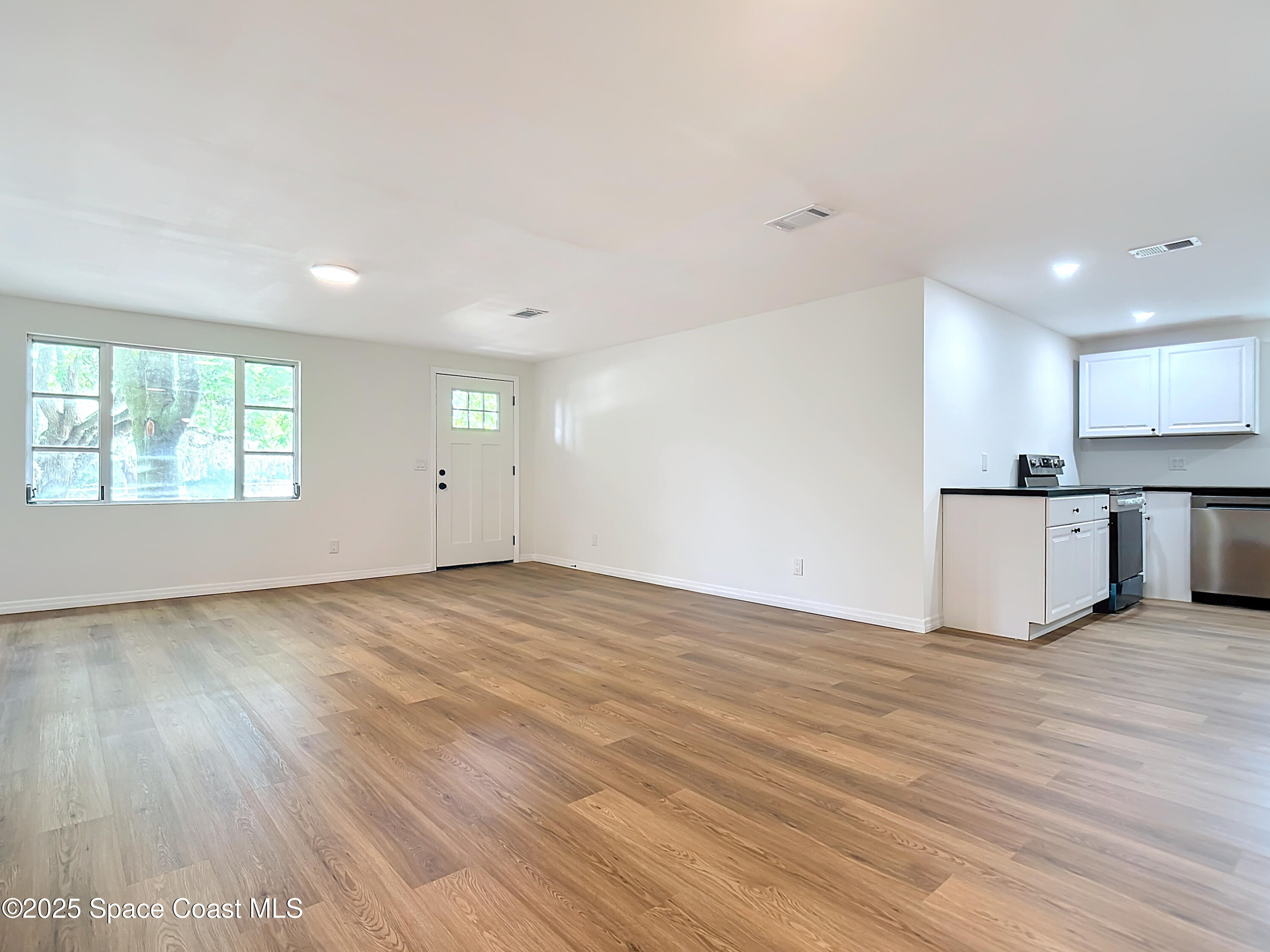 392 Arora Boulevard Orange Park, FL 32073 - Photo 11 of 45 a view of empty room with wooden floor and window