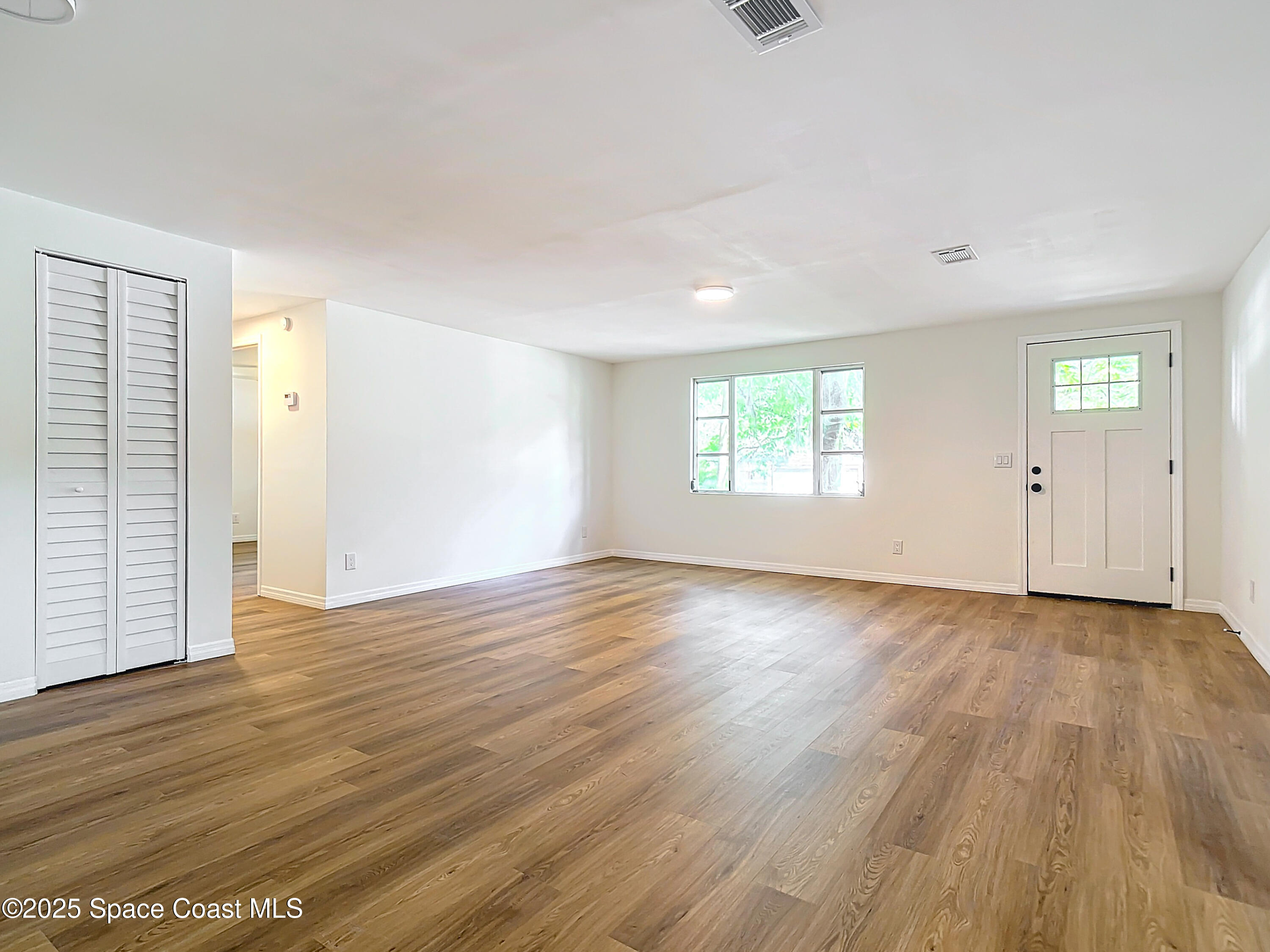392 Arora Boulevard Orange Park, FL 32073 - Photo 16 of 45 an empty room with wooden floor and windows