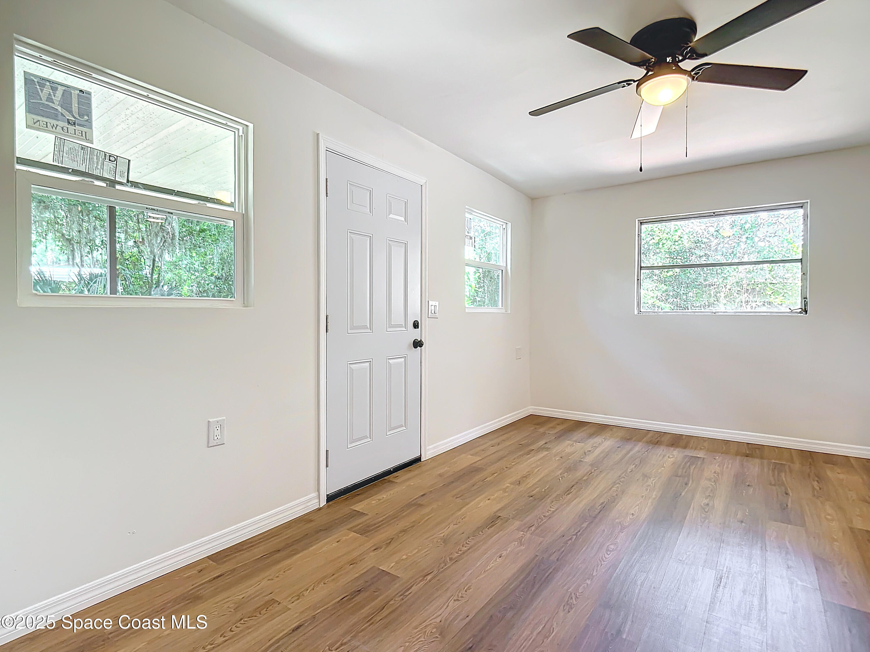 392 Arora Boulevard Orange Park, FL 32073 - Photo 17 of 45 wooden floor in an empty room with a window