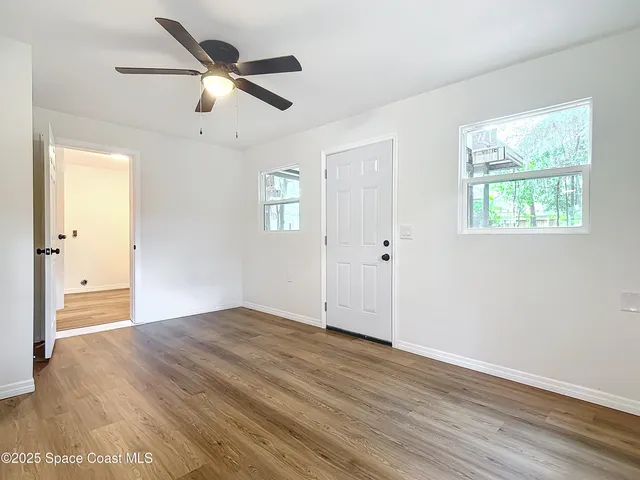 wooden floor in an empty room with a window