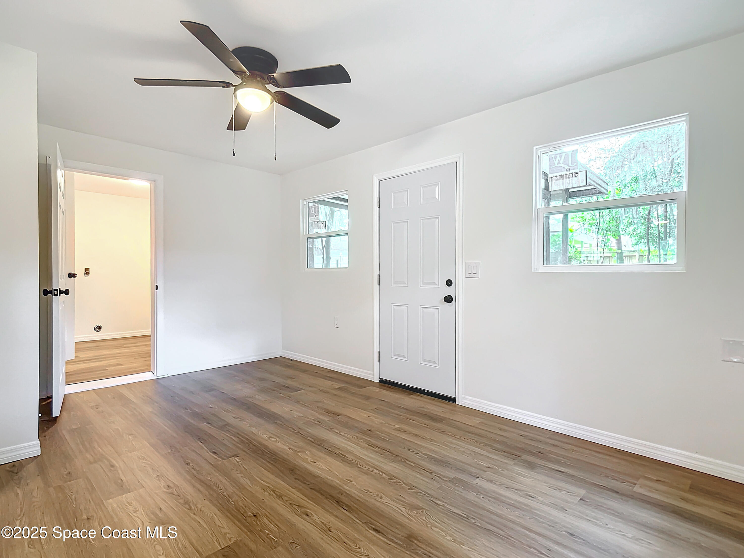 392 Arora Boulevard Orange Park, FL 32073 - Photo 18 of 45 wooden floor in an empty room with a window