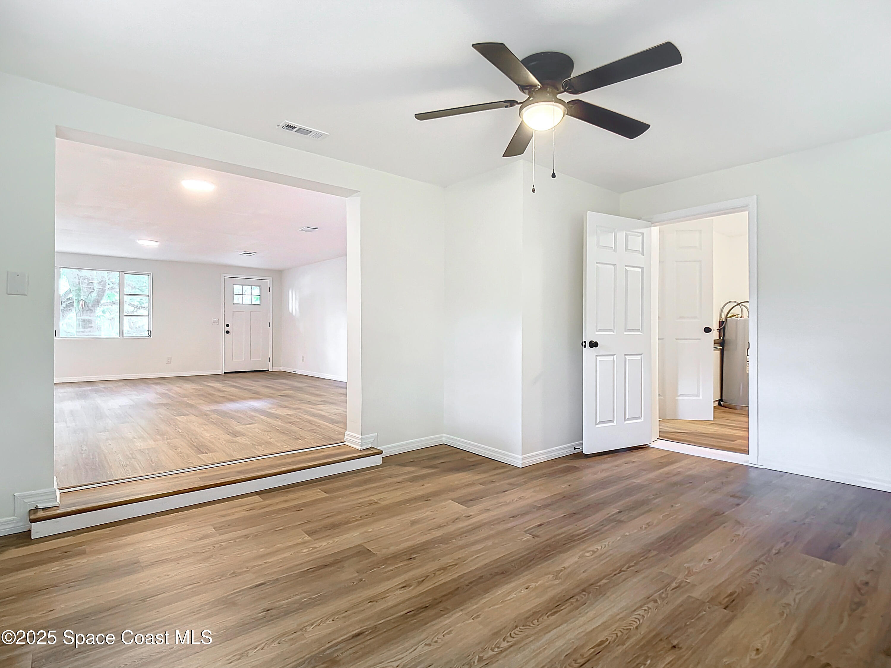 392 Arora Boulevard Orange Park, FL 32073 - Photo 19 of 45 a view of a livingroom with wooden floor and a ceiling fan