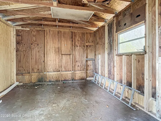 a view of a room with wooden walls