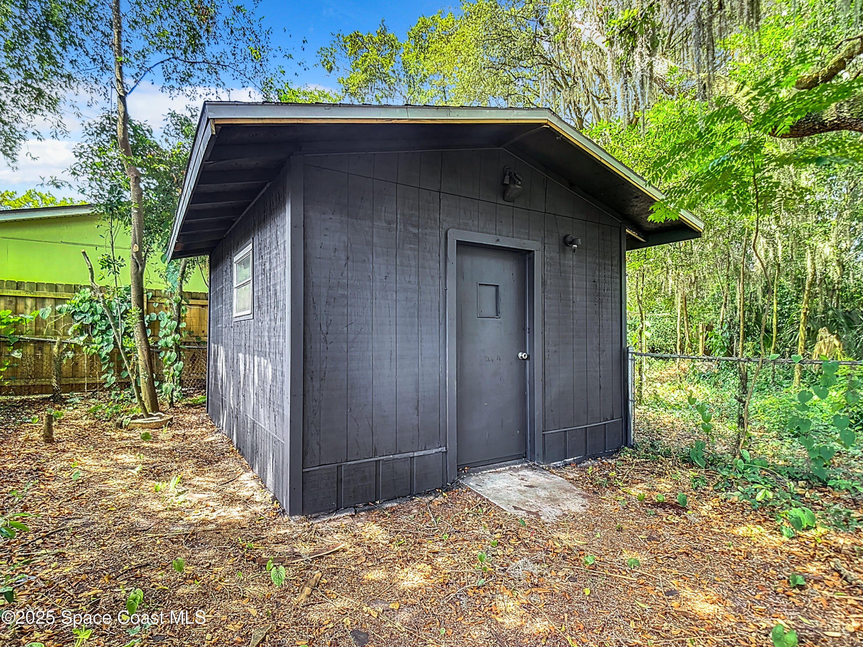 392 Arora Boulevard Orange Park, FL 32073 - Photo 38 of 45 a backyard of a house with large trees and wooden fence
