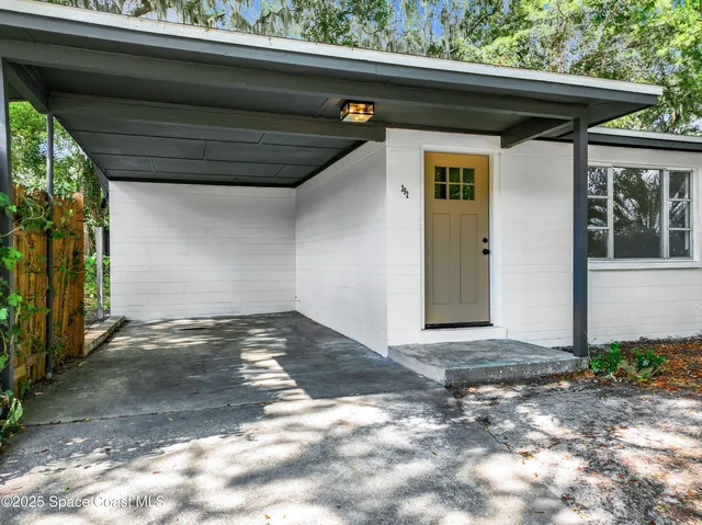 a view of backyard with plants and trees