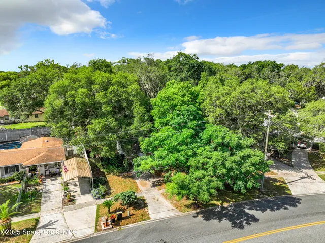 an aerial view of a house with yard