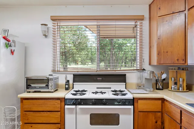 a kitchen with stainless steel appliances granite countertop a stove and a refrigerator