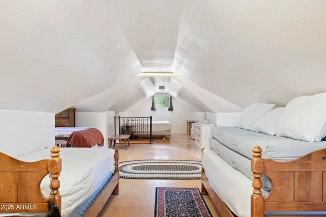 a bedroom with furniture and a lamp