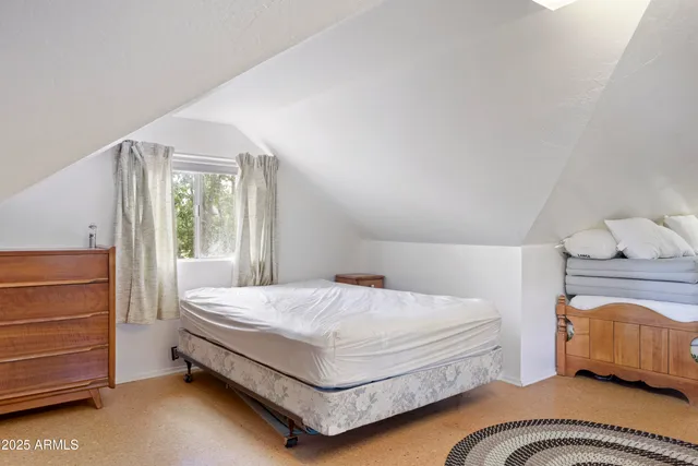 a bedroom with a bed and chair