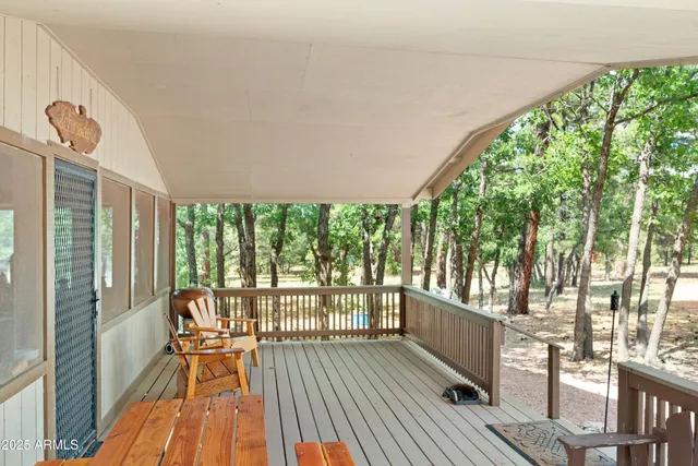 a view of a room with wooden floor and furniture