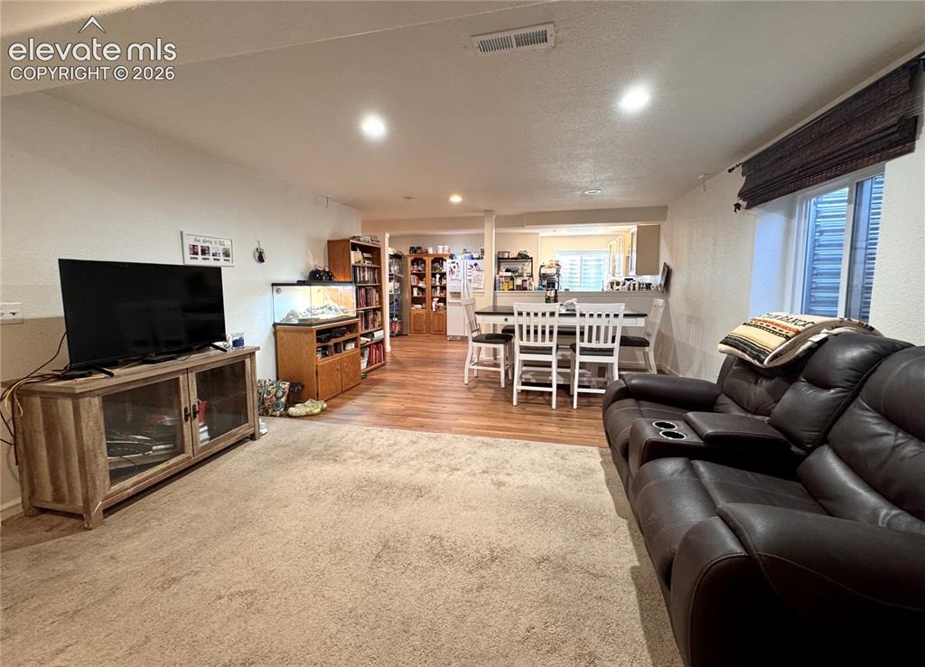 9362 St.George Road Peyton, CO 80831 - Photo 20 of 32 a living room with furniture and a flat screen tv