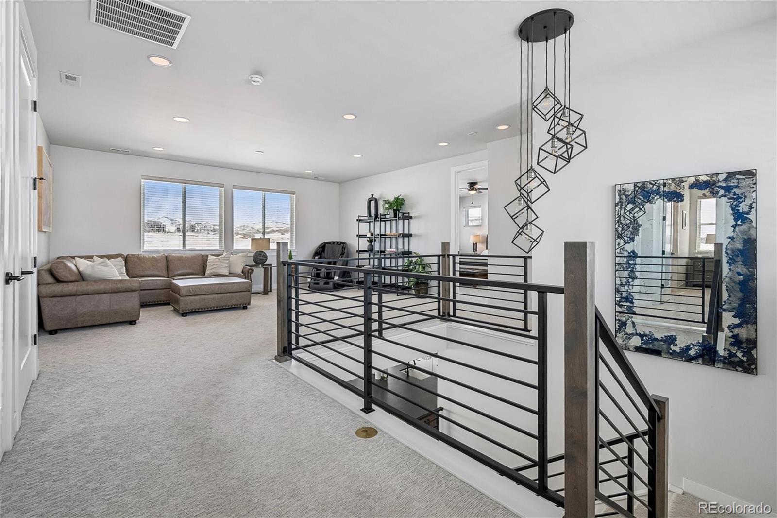 5601 Raintree Drive Parker, CO 80134 - Photo 22 of 50 a living room with furniture and a chandelier