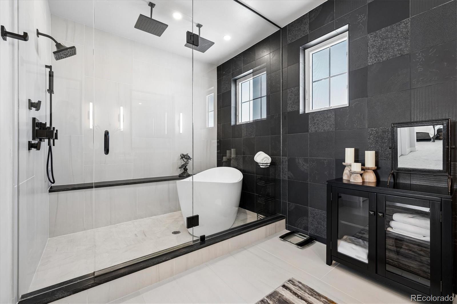 5601 Raintree Drive Parker, CO 80134 - Photo 29 of 50 a bathroom with a bathtub and a shower