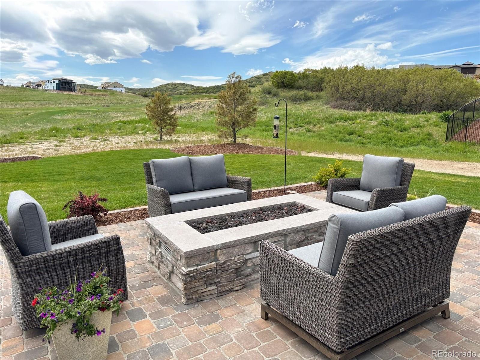 5601 Raintree Drive Parker, CO 80134 - Photo 48 of 50 a view of a patio with couches potted plants and a big yard