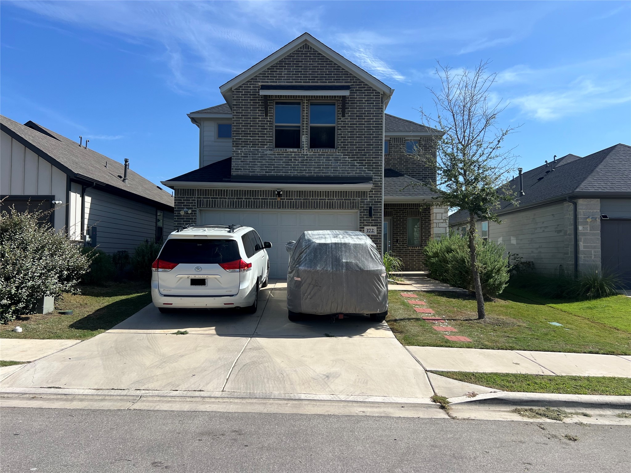 172 Coppers Way Elgin, TX 78621 - Photo 2 of 27 Two-story brick exterior defines this modern residence with an attached front garage.