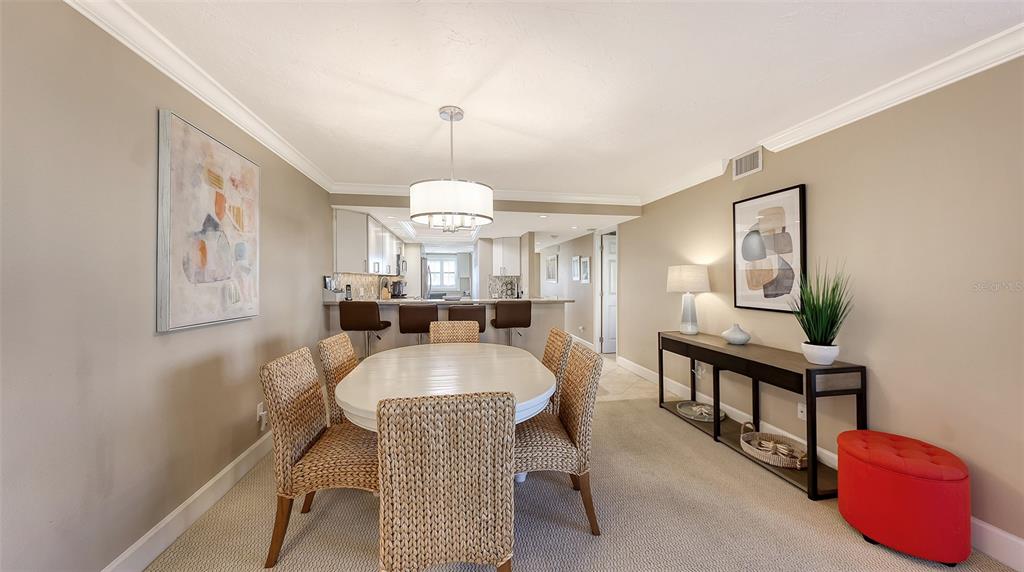 5780 Midnight Pass Road, Unit 207 Sarasota, FL 34242 - Photo 11 of 35 a dining room with furniture and window