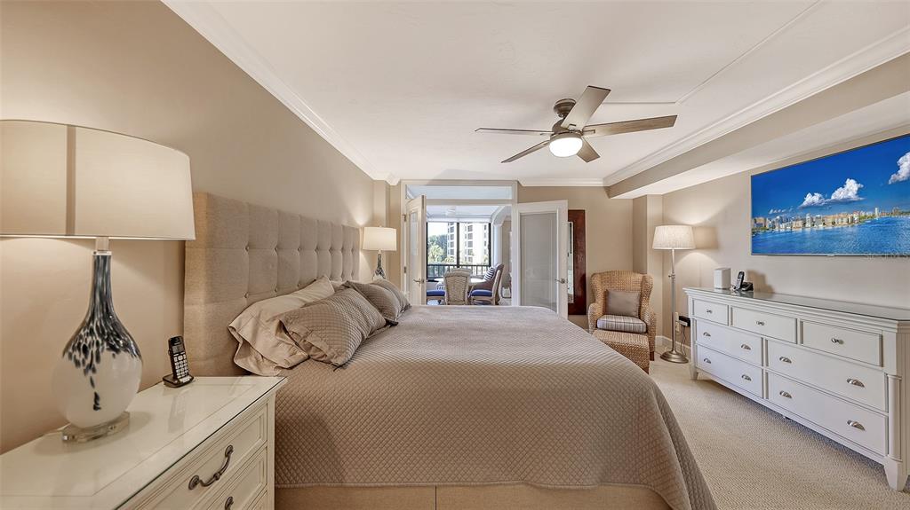 5780 Midnight Pass Road, Unit 207 Sarasota, FL 34242 - Photo 18 of 35 a bedroom with a bed and a dresser