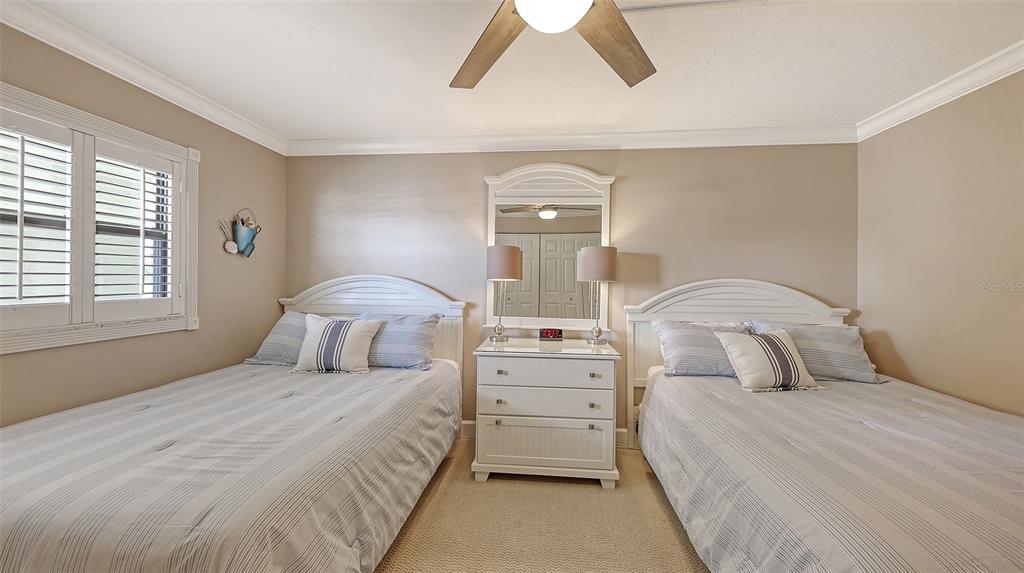 5780 Midnight Pass Road, Unit 207 Sarasota, FL 34242 - Photo 24 of 35 a bedroom with a bed and a night stand