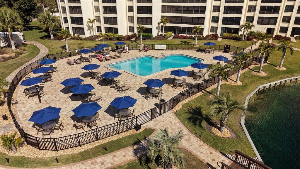 5780 Midnight Pass Road, Unit 207 Sarasota, FL 34242 - Photo 28 of 35 a view of swimming pool with outdoor seating