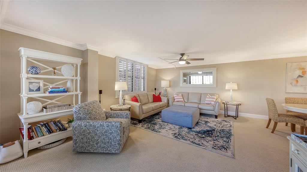 5780 Midnight Pass Road, Unit 207 Sarasota, FL 34242 - Photo 4 of 35 a living room with furniture and a book shelf