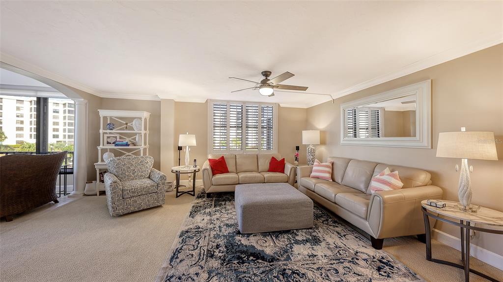 5780 Midnight Pass Road, Unit 207 Sarasota, FL 34242 - Photo 6 of 35 a living room with furniture and a large window