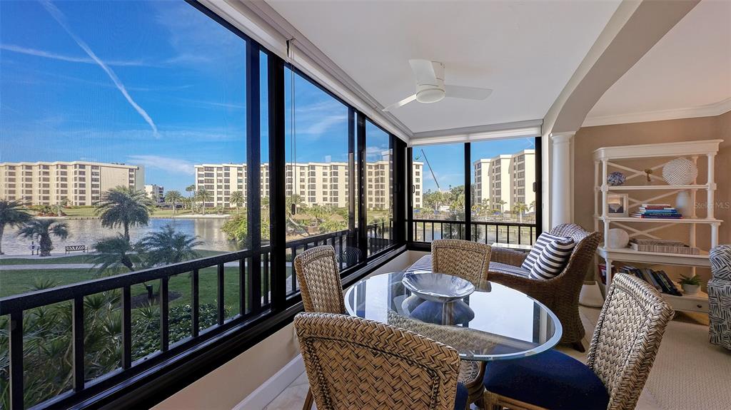 5780 Midnight Pass Road, Unit 207 Sarasota, FL 34242 - Photo 7 of 35 a living room with furniture and a floor to ceiling window