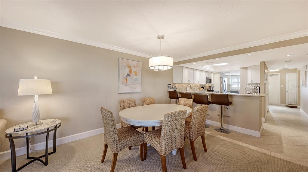 5780 Midnight Pass Road, Unit 207 Sarasota, FL 34242 - Photo 9 of 35 a view of a dining room with furniture