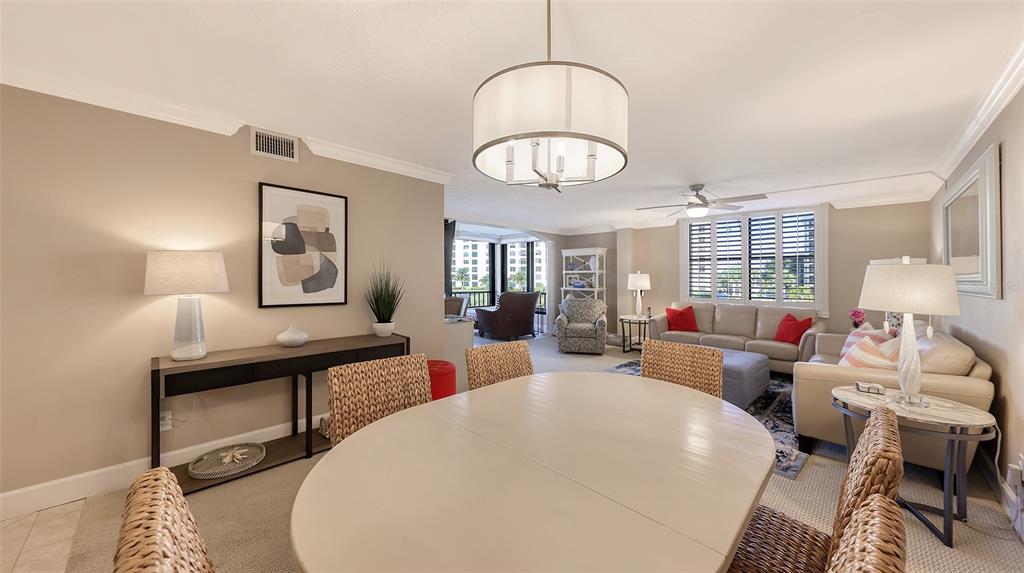 5780 Midnight Pass Road, Unit 207 Sarasota, FL 34242 - Photo 10 of 35 a living room with furniture a chandelier and a window
