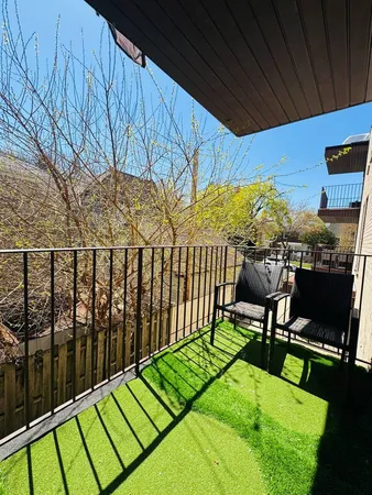 a view of a chairs and table in the balcony