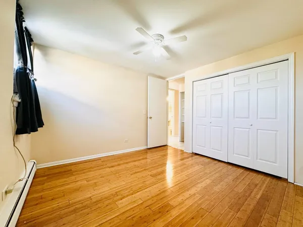 an empty room with wooden floor and closet