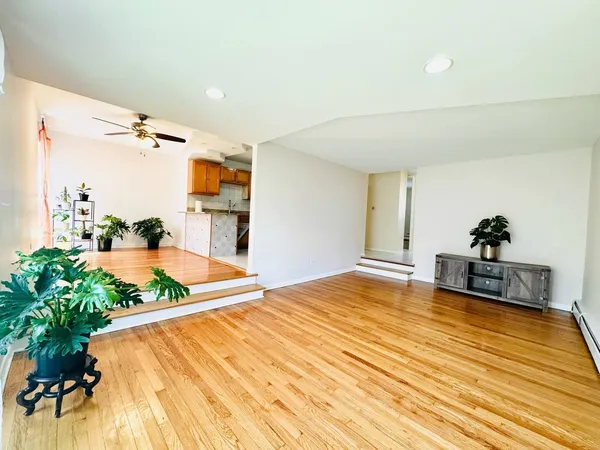 a bedroom with a bed dresser and a potted plant