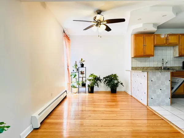 a view of cabinets and patio with wooden floor