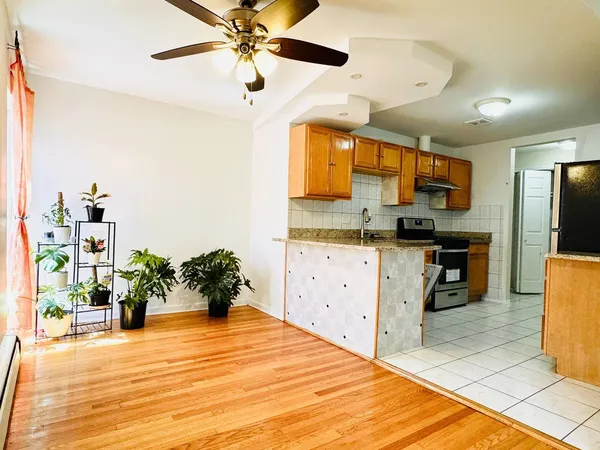 a kitchen with kitchen island a counter top space a sink stainless steel appliances and cabinets