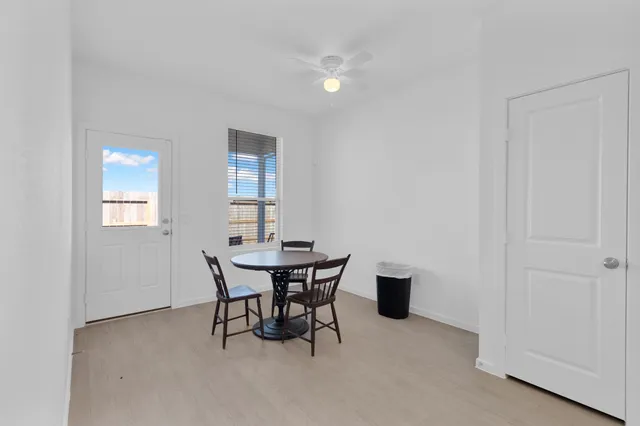 a view of a dining room with furniture and window