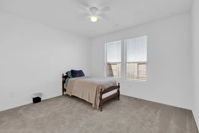 a spacious bedroom with a bed and a window