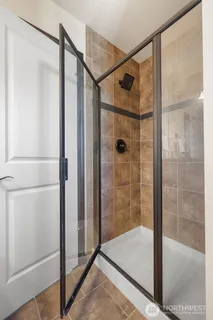 a bathroom with a glass shower door