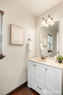 a bathroom with a sink vanity and a mirror