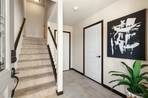 a view of entryway with stairs and wooden floor