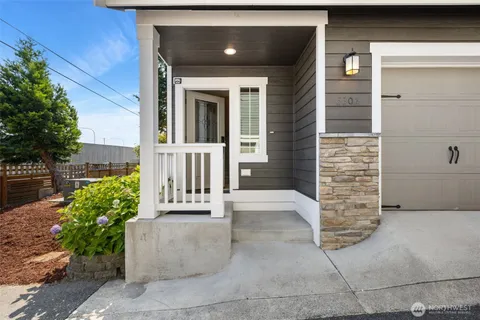 a view of a house with a large window and flower pot