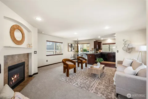 a living room with furniture a window and a fireplace