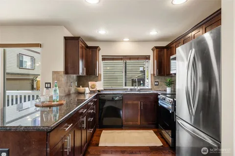 a kitchen with a sink refrigerator and cabinets