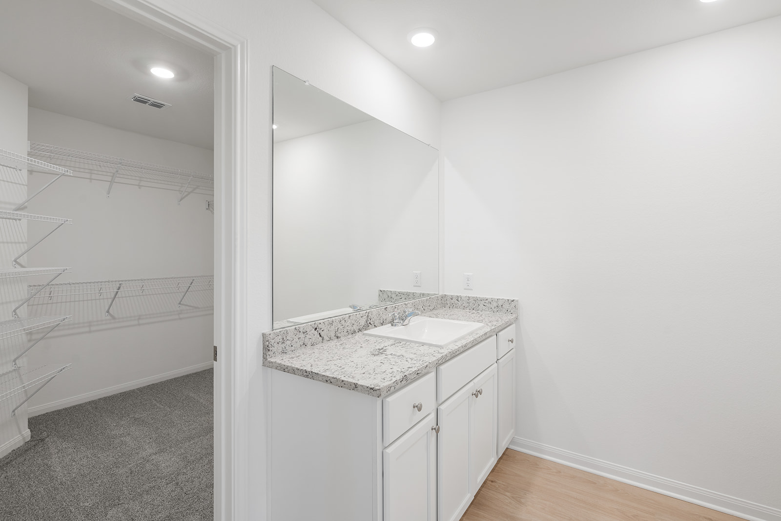 112 Paria Court Jarrell, TX 76537 - Photo 6 of 8 a bathroom with a granite countertop sink and a mirror