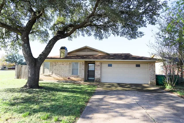 a front view of house with yard and trees