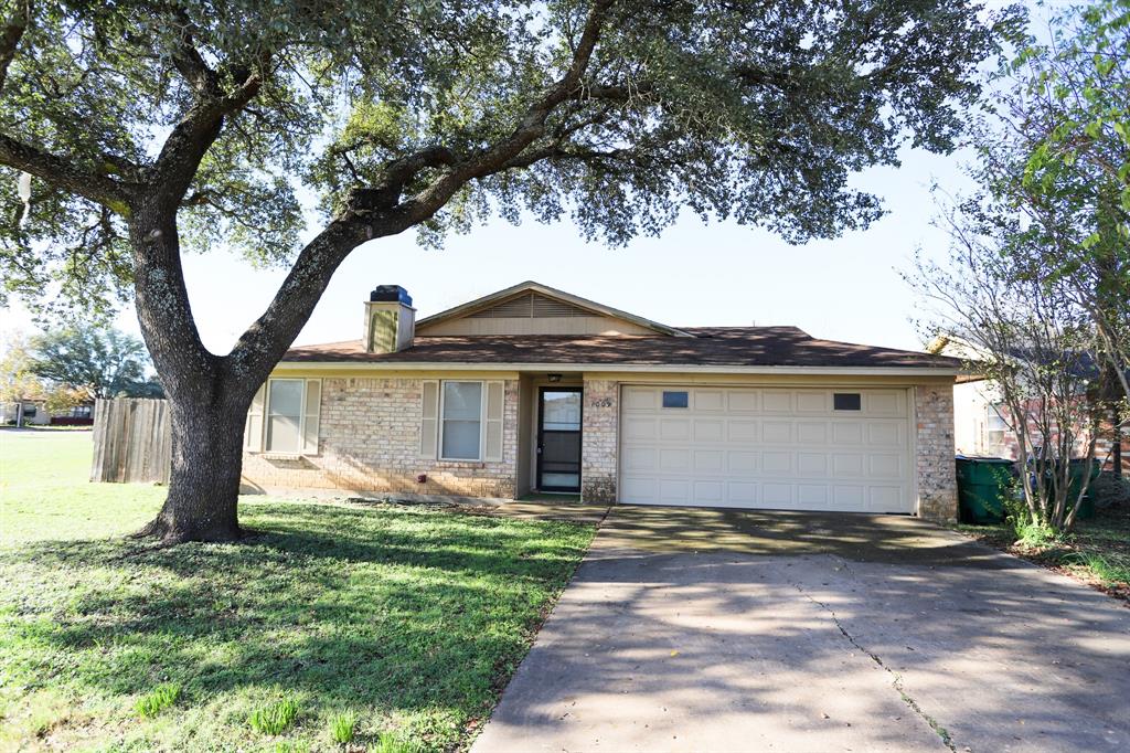 1009 Buchanan Street McGregor, TX 76657 - Photo 1 of 14 a front view of house with yard and trees
