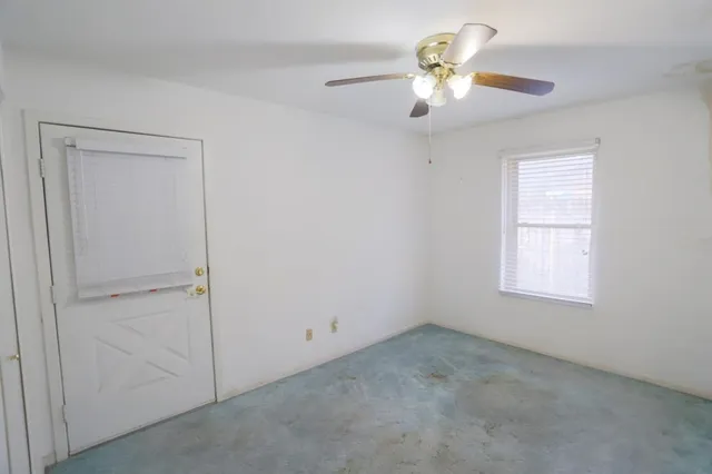 a view of a window and a chandelier fan in a room