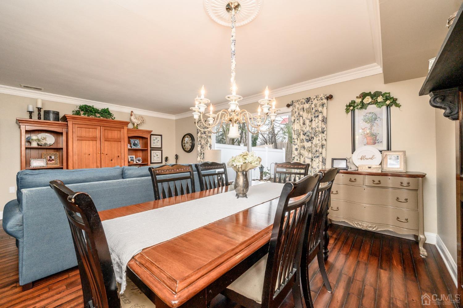 607 Randall Way Aberdeen, NJ 07747 - Photo 11 of 35 a view of a dining room with furniture window and wooden floor
