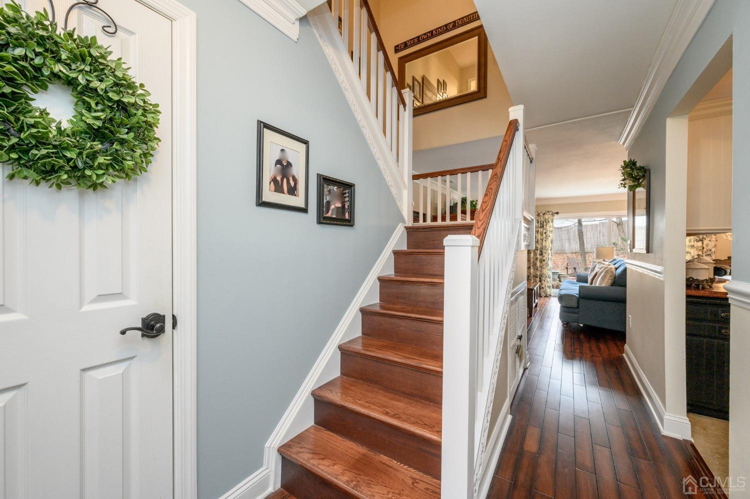 607 Randall Way Aberdeen, NJ 07747 - Photo 16 of 35 a view of a hallway with wooden floor and staircase
