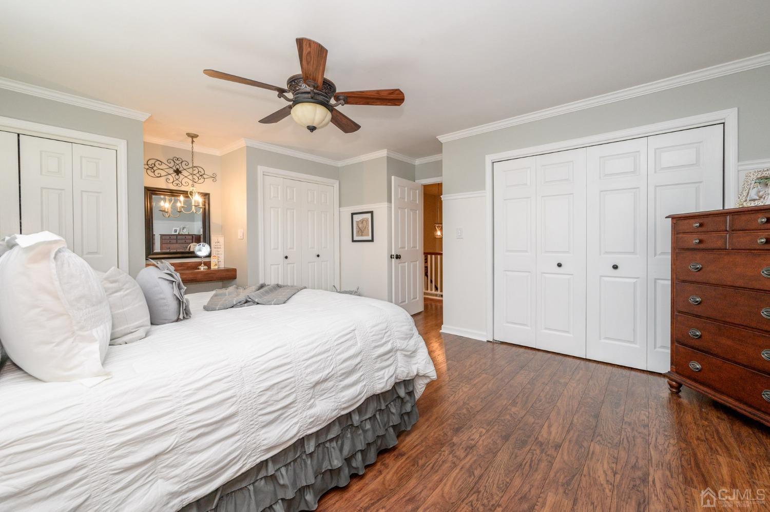 607 Randall Way Aberdeen, NJ 07747 - Photo 18 of 35 a bedroom with a bed and wooden floor